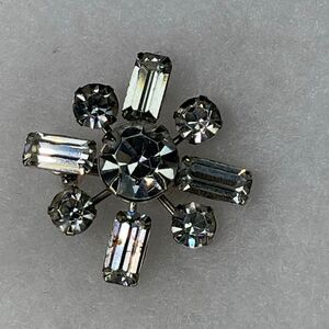 Vintage Midcentury starburst brooch W/ round and baguette cut rhinestones.